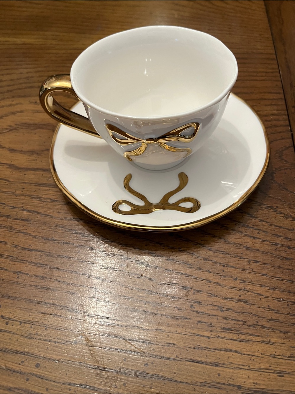 White and Gold Porcelain Bow Teacup and Saucer